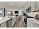 Well-designed kitchen featuring an island, stainless steel appliances, and a view of the fireplace at 15360 Cardonia Rd, Fishers, IN 46037