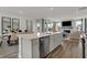 Open-concept kitchen with modern appliances, island seating, and a seamless connection to the living space at 15360 Cardonia Rd, Fishers, IN 46037