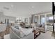 Open concept living room featuring hardwood floors, neutral furniture, and modern lighting at 15360 Cardonia Rd, Fishers, IN 46037