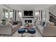Beautifully decorated living room with plush sofas, a modern fireplace, and large windows at 15360 Cardonia Rd, Fishers, IN 46037