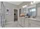 Bright main bathroom featuring double vanities, quartz countertops, and a frameless glass shower with marble tile at 15360 Cardonia Rd, Fishers, IN 46037