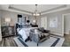 Relaxing main bedroom with a tray ceiling, a sitting area, and neutral decor creating a peaceful retreat at 15360 Cardonia Rd, Fishers, IN 46037