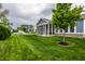 Beautiful backyard showcases lush green lawn, mature tree, and screened-in porch at 15596 Edenvale Dr, Westfield, IN 46074