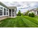 Well-maintained lawn featuring screened porch, seamlessly blending indoor and outdoor living at 15596 Edenvale Dr, Westfield, IN 46074