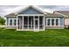 Backyard features a stylish screened-in porch, perfect for outdoor gatherings and relaxation at 15596 Edenvale Dr, Westfield, IN 46074