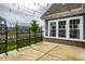 Exposed aggregate concrete backyard patio with decorative privacy screen and string lights at 15596 Edenvale Dr, Westfield, IN 46074