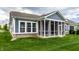 Home showcasing manicured lawn, complemented by a charming screened-in porch for relaxation at 15596 Edenvale Dr, Westfield, IN 46074