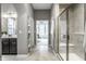 Hallway leading to bath with glass enclosed shower and decorative shelving at 15596 Edenvale Dr, Westfield, IN 46074