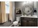 Well-lit bathroom with a modern vanity, decorative mirror, and neutral color palette at 15596 Edenvale Dr, Westfield, IN 46074