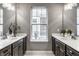 Bathroom with dual vanities, matching mirrors, and a bright window that brings in natural light at 15596 Edenvale Dr, Westfield, IN 46074