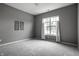 Bedroom featuring gray carpet, window with curtain, and wall art at 15596 Edenvale Dr, Westfield, IN 46074