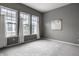 Bedroom featuring gray carpet and walls with three windows that brighten the room at 15596 Edenvale Dr, Westfield, IN 46074