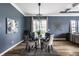 Elegant dining room featuring a glass table, upholstered chairs, and modern decor at 15596 Edenvale Dr, Westfield, IN 46074