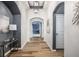 Elegant hallway featuring arched doorways, stylish console table, and decorative artwork on display at 15596 Edenvale Dr, Westfield, IN 46074