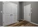 Hallway with wood look floors, gray walls, a closet and door at 15596 Edenvale Dr, Westfield, IN 46074