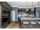 Bright kitchen featuring gray cabinets, granite countertops, modern appliances, island, and hardwood floors at 15596 Edenvale Dr, Westfield, IN 46074