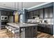 Modern kitchen featuring a large island with seating, pendant lighting, and sleek appliances at 15596 Edenvale Dr, Westfield, IN 46074