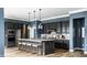 Stylish kitchen with dark cabinetry, stainless steel appliances, and a large island with seating at 15596 Edenvale Dr, Westfield, IN 46074