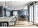 Open-concept kitchen featuring a large island with seating, pendant lighting, and access to the backyard at 15596 Edenvale Dr, Westfield, IN 46074