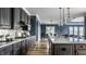 Modern kitchen with gray cabinets, granite countertops, stainless steel appliances, and open layout at 15596 Edenvale Dr, Westfield, IN 46074