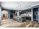 Modern kitchen featuring a large island with seating, pendant lighting, and sleek appliances at 15596 Edenvale Dr, Westfield, IN 46074