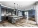 Open-concept kitchen featuring a large island with seating, pendant lighting, and sleek appliances at 15596 Edenvale Dr, Westfield, IN 46074