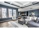 Open concept living room flowing into kitchen with a tray ceiling and plentiful natural light at 15596 Edenvale Dr, Westfield, IN 46074