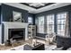 Bright living room with fireplace, mantel, large windows, and stylish decor at 15596 Edenvale Dr, Westfield, IN 46074