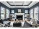 Spacious living room featuring a fireplace, custom built-ins, and ample natural light at 15596 Edenvale Dr, Westfield, IN 46074