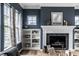 Cozy living room features built-in bookshelves, a fireplace, and ample natural light at 15596 Edenvale Dr, Westfield, IN 46074