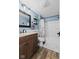 Well-lit bathroom showcases a wood vanity, granite countertops, and updated fixtures at 170 W Broadway St, Greenwood, IN 46142