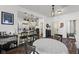 Dining area with hardwood floors next to an open kitchen with barstool seating at 170 W Broadway St, Greenwood, IN 46142