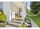 Cozy front porch with seating and lush landscaping at 170 W Broadway St, Greenwood, IN 46142