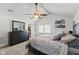 Well-lit main bedroom with ceiling fan, dresser, and decor at 170 W Broadway St, Greenwood, IN 46142