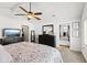 Spacious main bedroom with ceiling fan, TV, dresser, and access to closet at 170 W Broadway St, Greenwood, IN 46142