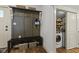 Cozy mudroom featuring a bench, coat rack, and access to the laundry area at 170 W Broadway St, Greenwood, IN 46142
