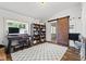 Bright playroom with natural light, desk, shelving, wood floors, and sliding barn door at 170 W Broadway St, Greenwood, IN 46142
