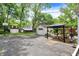 Spacious backyard with gazebo, detached garage, and basketball hoop at 1725 W 53Rd St, Indianapolis, IN 46228