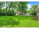 Expansive backyard featuring lush green grass, mature trees, storage shed, and detached garage at 1725 W 53Rd St, Indianapolis, IN 46228