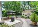Outdoor space featuring a gazebo, fire pit, detached garage, and lush greenery at 1725 W 53Rd St, Indianapolis, IN 46228