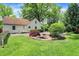 Landscaped backyard with fire pit and well-maintained lawn at 1725 W 53Rd St, Indianapolis, IN 46228