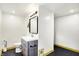 Bathroom with sleek modern vanity, stylish mirror, and ample lighting in a modern renovated space at 1725 W 53Rd St, Indianapolis, IN 46228