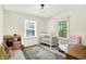 Bright bedroom showcasing a crib, wooden floors, two large windows with lots of natural light at 1725 W 53Rd St, Indianapolis, IN 46228