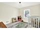 Bedroom features a crib near the window, hardwood flooring, and neutral walls at 1725 W 53Rd St, Indianapolis, IN 46228