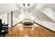 Open bedroom floor plan with hard wood floors, bright white paint, and an olive colored chaise lounge at 1725 W 53Rd St, Indianapolis, IN 46228