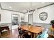 Dining room with an updated light fixture, hardwood floors and neutral paint at 1725 W 53Rd St, Indianapolis, IN 46228