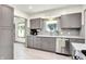 Well-lit kitchen features stainless steel appliances and gray cabinetry at 1725 W 53Rd St, Indianapolis, IN 46228