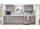 Charming kitchen boasts stainless steel dishwasher, granite countertops, and light gray cabinets at 1725 W 53Rd St, Indianapolis, IN 46228