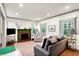 Bright living room with a painted brick fireplace, hardwood floors, and lots of light at 1725 W 53Rd St, Indianapolis, IN 46228