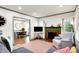 Inviting living room features a painted brick fireplace and an open floor plan at 1725 W 53Rd St, Indianapolis, IN 46228